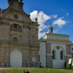 Na Łysej Górze widać barokowy klasztor z kamienną fasadą i zieloną kopułą.
