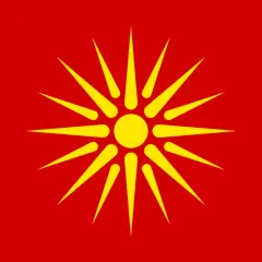 Czerwona flaga Macedonii z żółtym słońcem o ośmiu promieniach.
