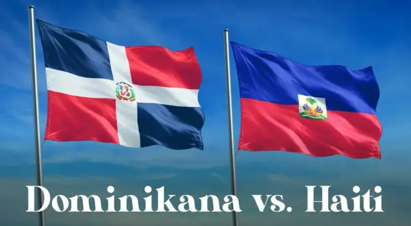 Dwie flagi powiewają na wietrze: dominikana flaga z białym krzyżem i herbem oraz flaga Haiti.