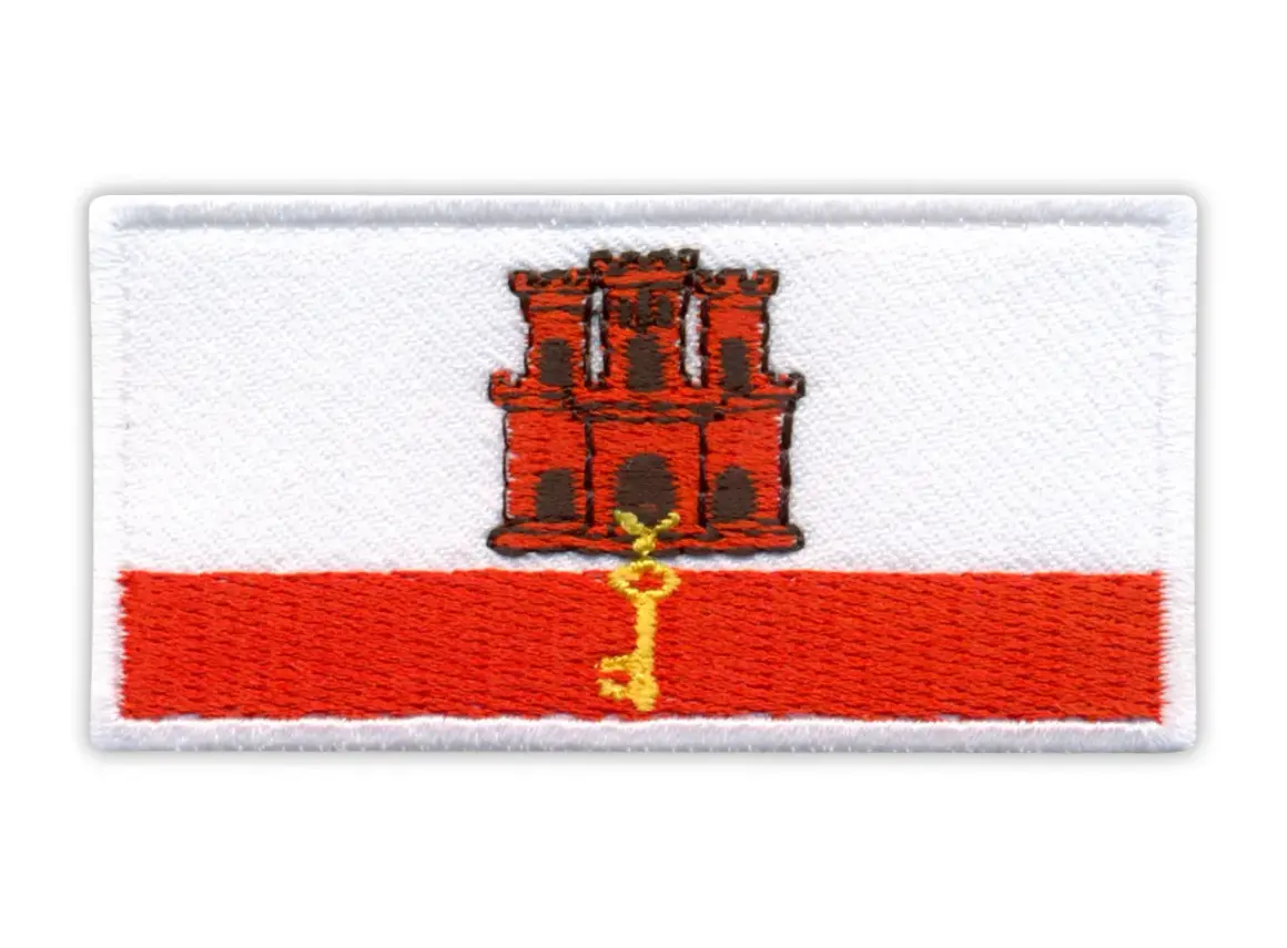 Naszywka z herbem Gibraltaru: czerwona twierdza z kluczem na białym tle i czerwonym pasie.