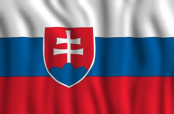 Flaga Słowacji powiewa na wietrze. Biały, niebieski i czerwony pas z herbem Słowacji po lewej stronie.